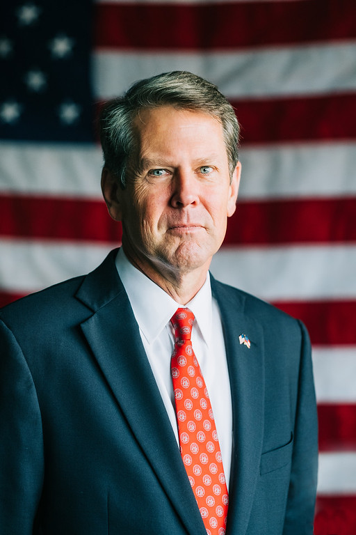 Governor Brian Kemp in suit and red tie