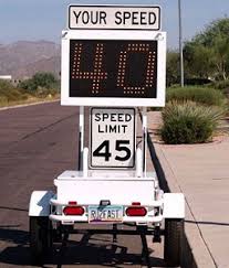 a white radar trailer with a speed limit sign and electronic sign