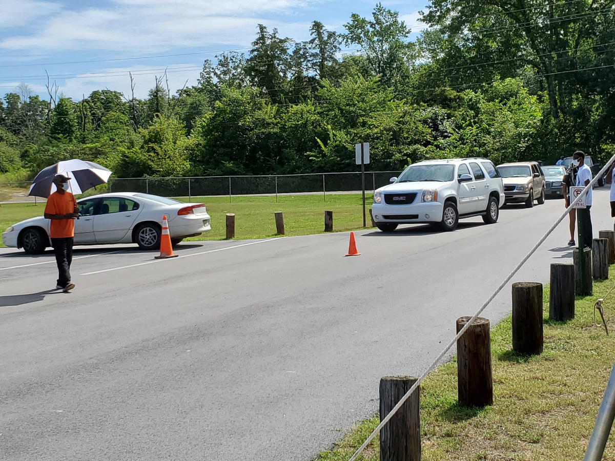 line of vehicles and a person holding an umbrella
